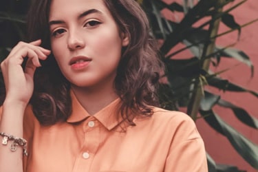 A woman wearing a salmon shirt.